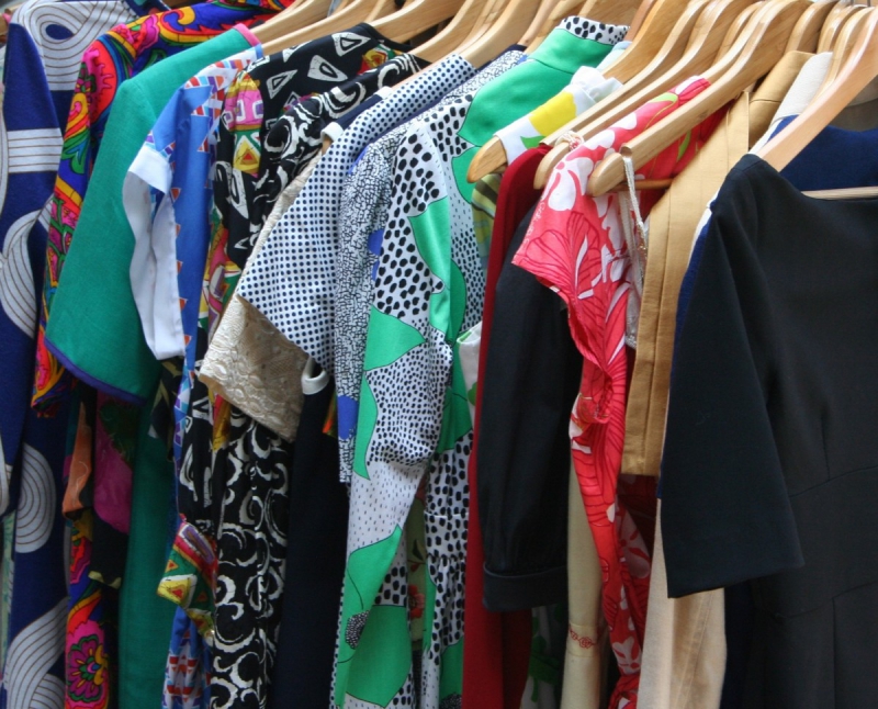 association-CASTILLON-min_dresses_apparel_clothing_clothes_clothes_hangers_wooden_hangers_retail_shop_closet-1149845
